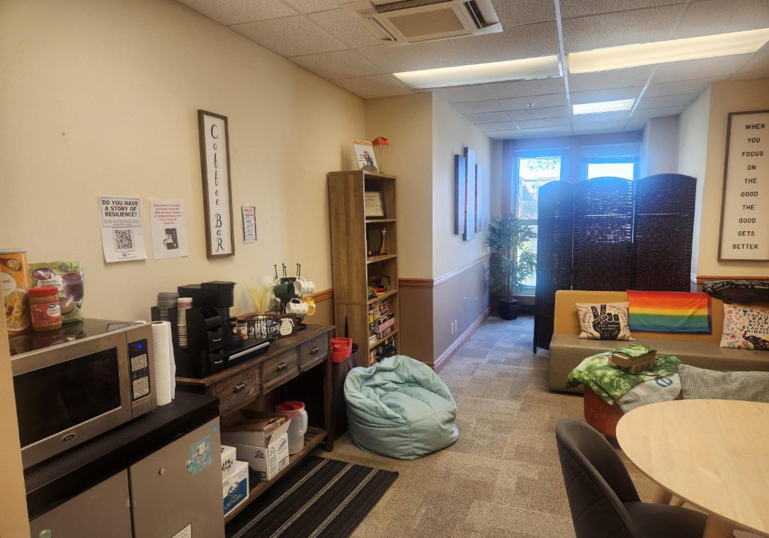 The Miner Oasis in 202 Norwood Hall, shown in the space is a coffee bar, beanbag chair and other seating, a table, craft supplies and games, and the massage chair.